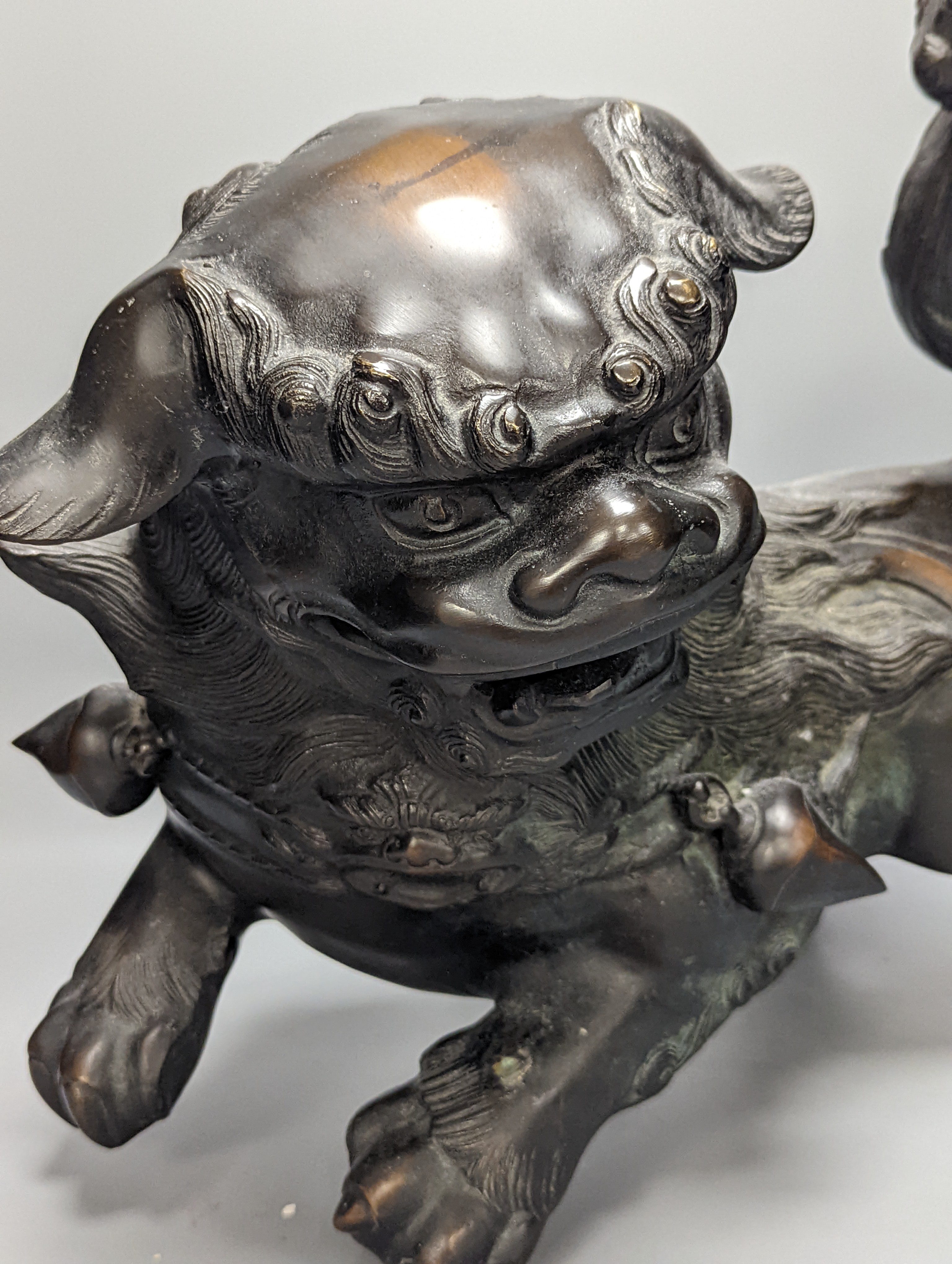 A large Chinese or Japanese bronze figure of a lion-dog or kara shi-shi, 45 cm long